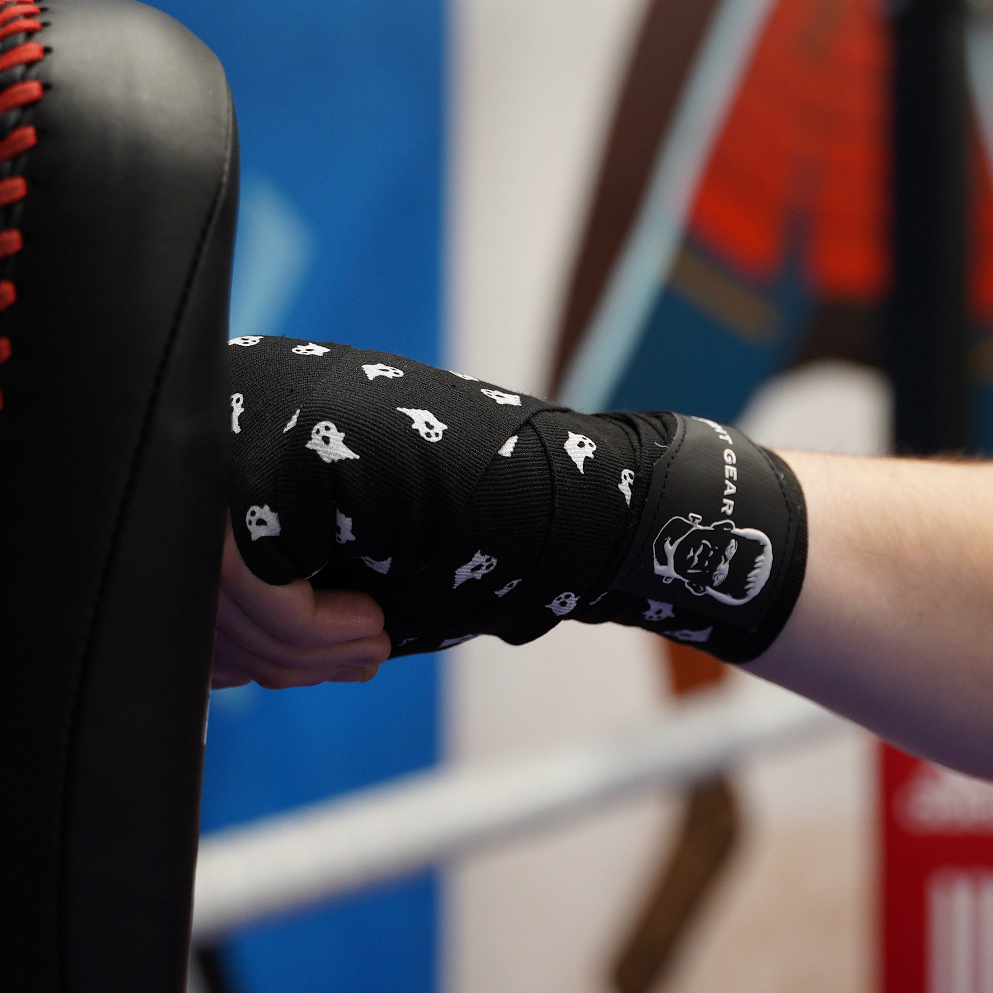 THS Fight Gear black with ghosts hand wraps hands wrapped jab pads left front view modelled