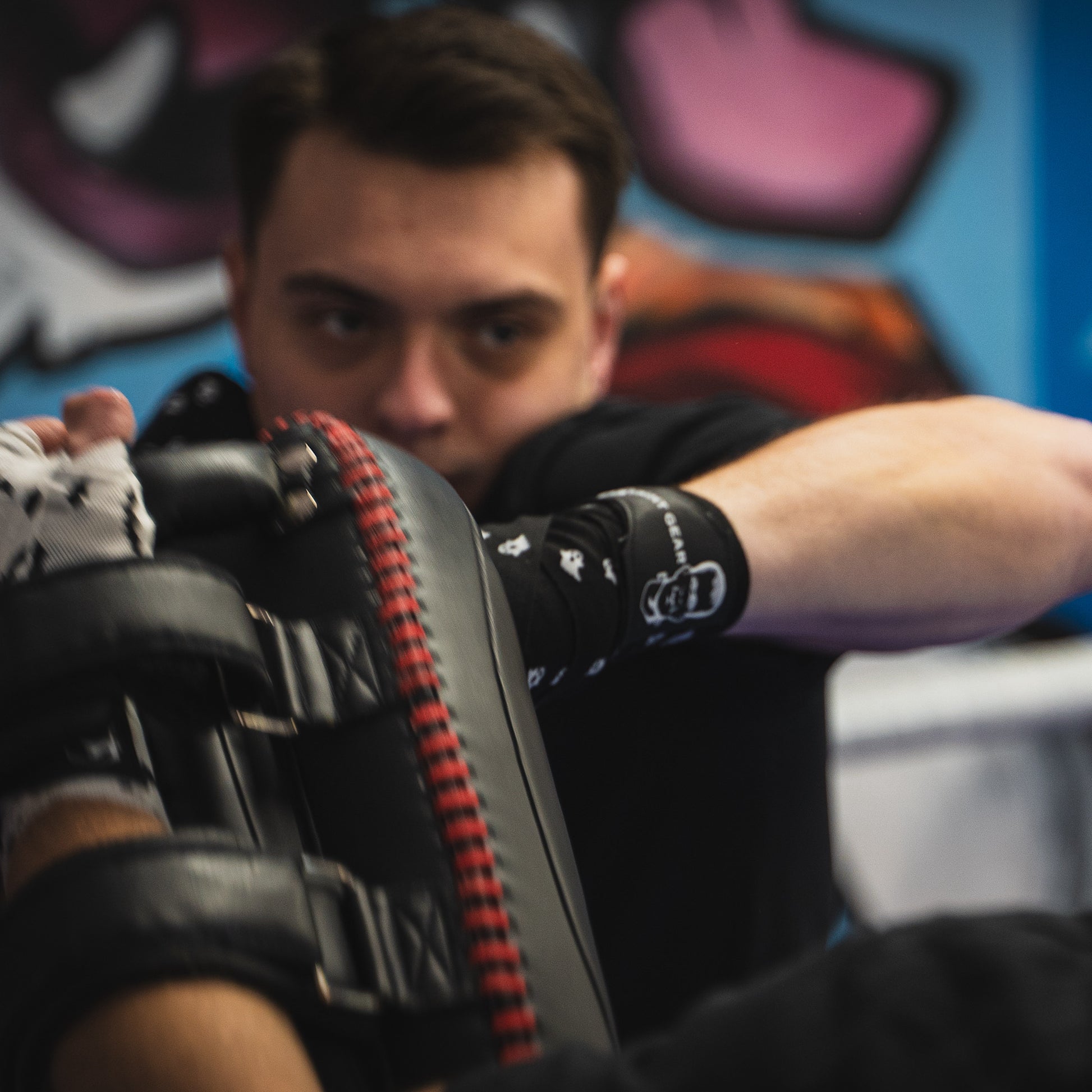 THS Fight Gear black with ghosts hand wraps hands wrapped fighter left hook front view modelled