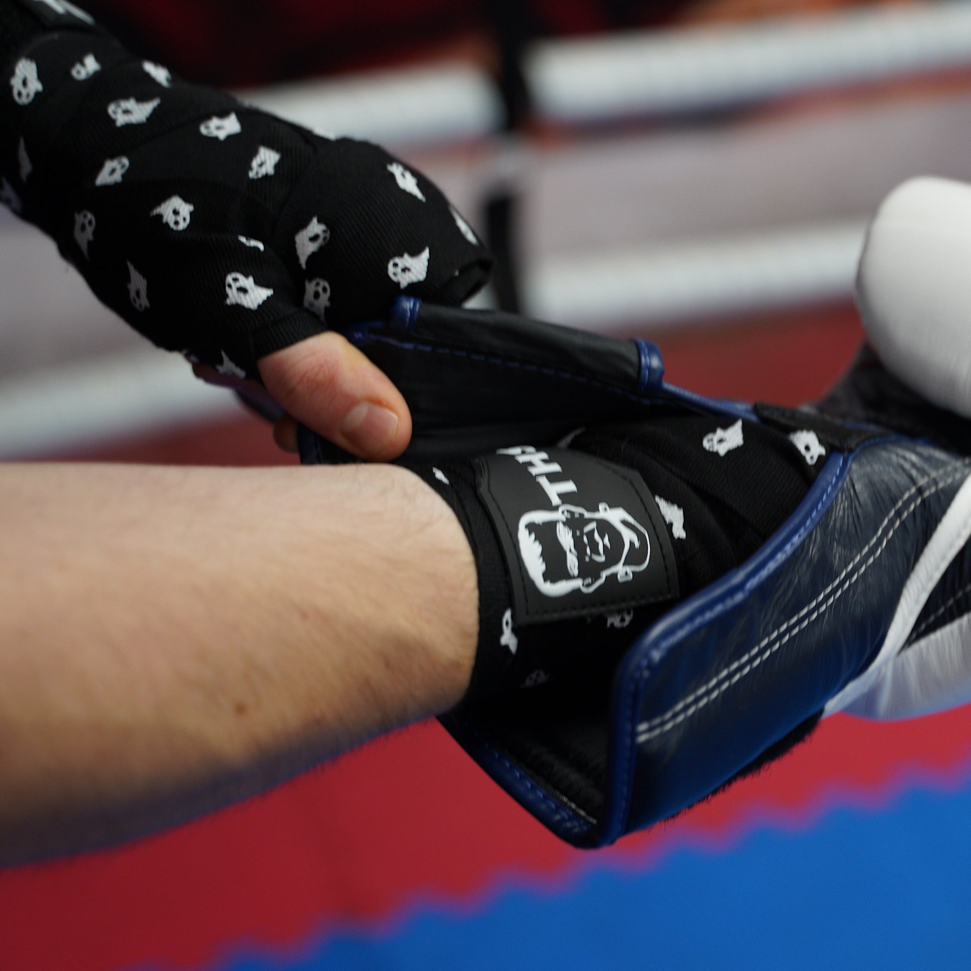 THS Fight Gear black with ghosts hand wraps hands wrapped fighter putting on glove modelled