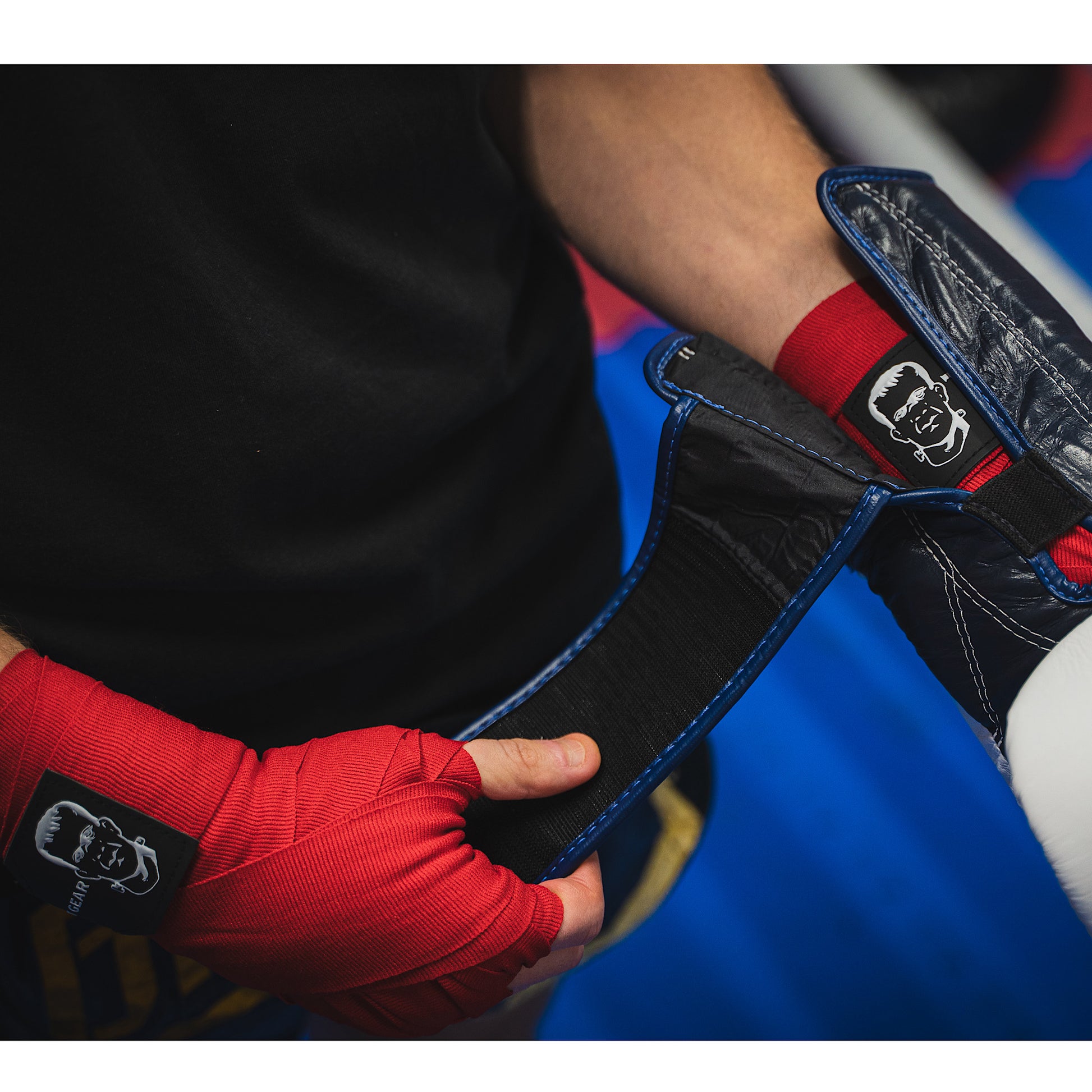 THS Fight Gear red hand wraps wrapped hands fighter putting on glove modelled