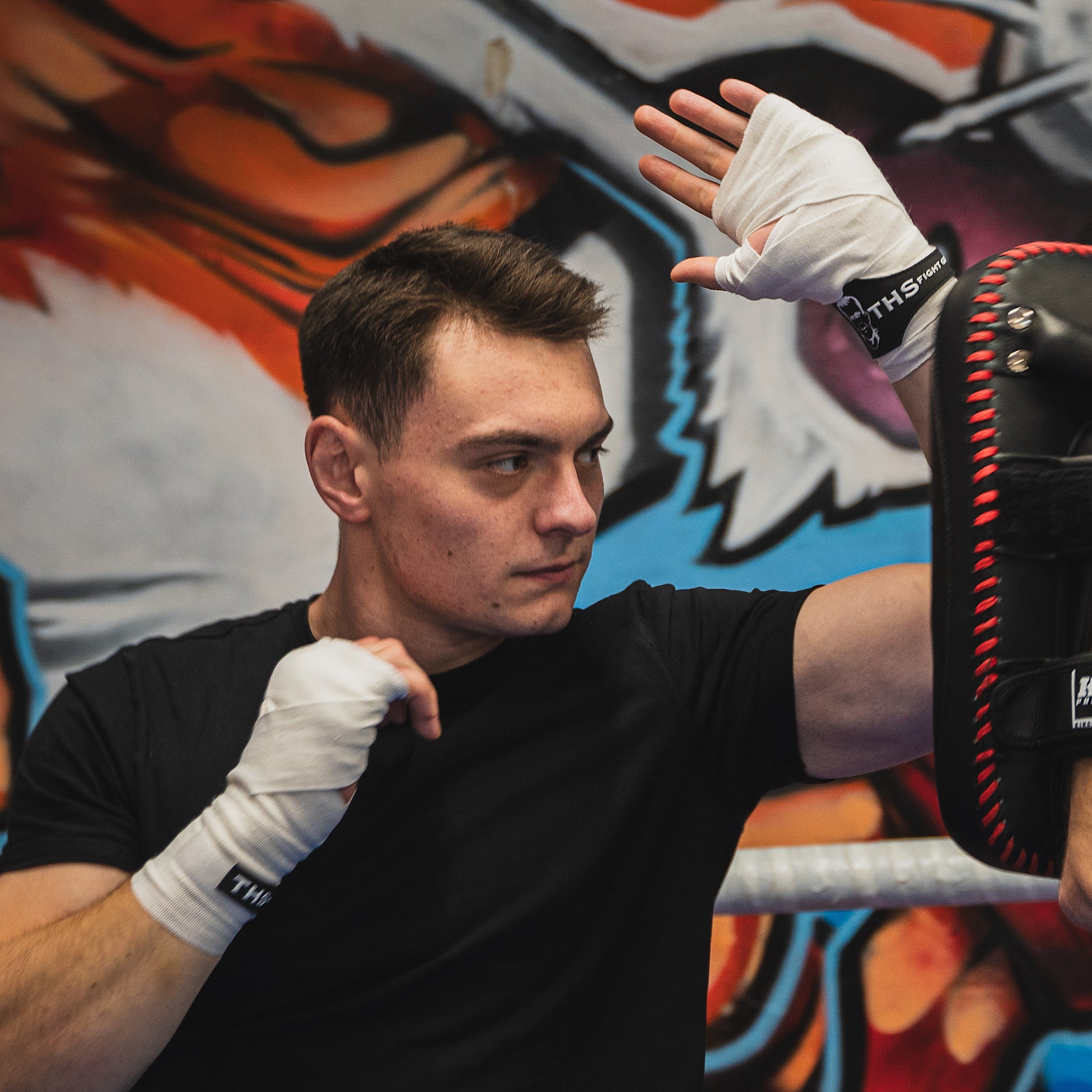 THS Fight Gear white hand wraps wrapped hands fighter action shot left elbow modelled