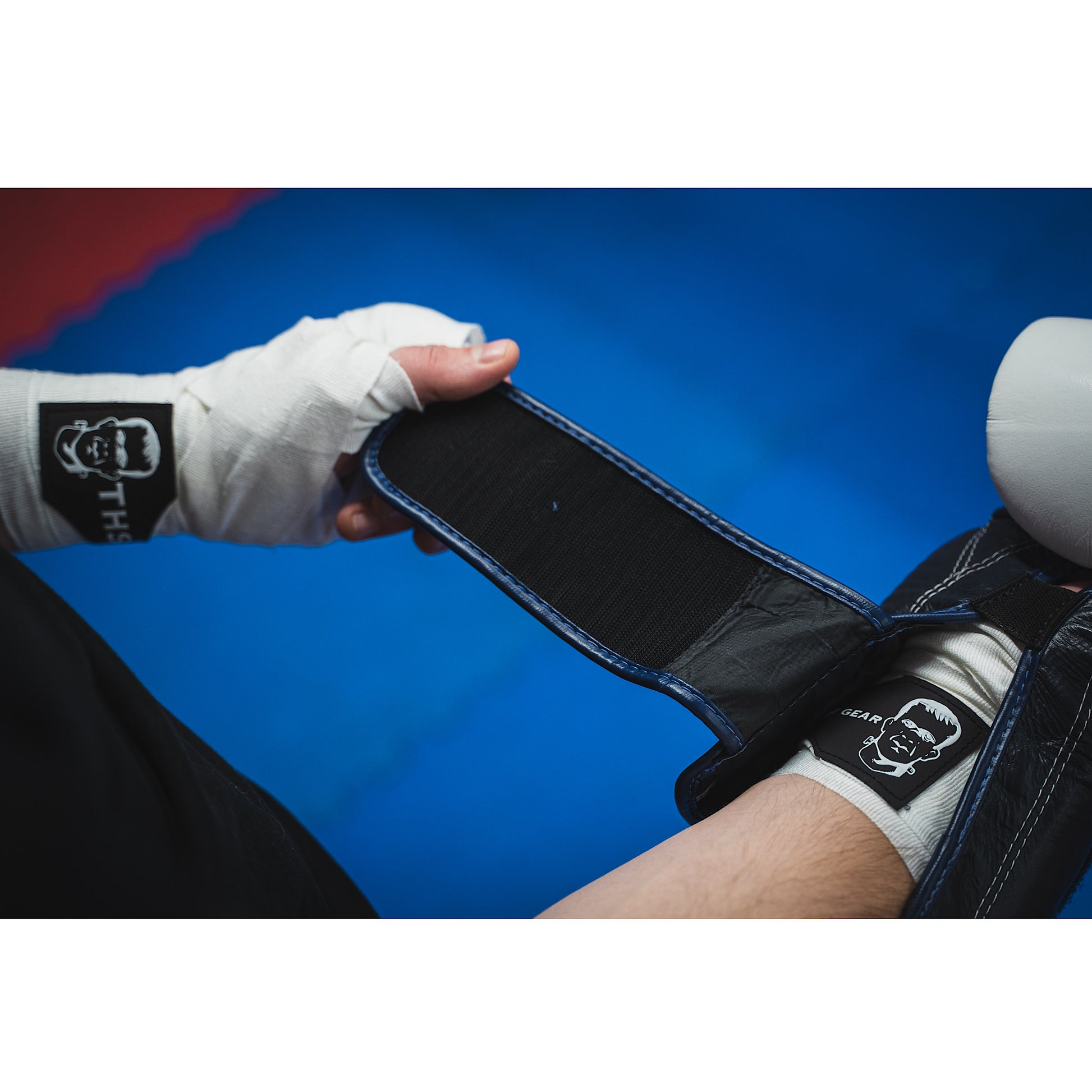 THS Fight Gear white hand wraps wrapped hands putting on glove modelled