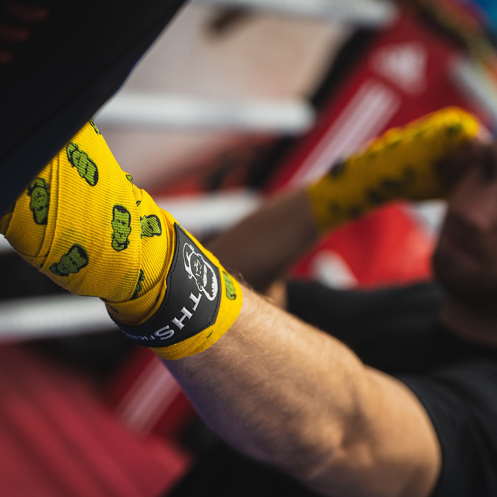 THS Fight Gear yellow with Frankenstein monster hand wraps hands wrapped fighter jab pad front left view modelled