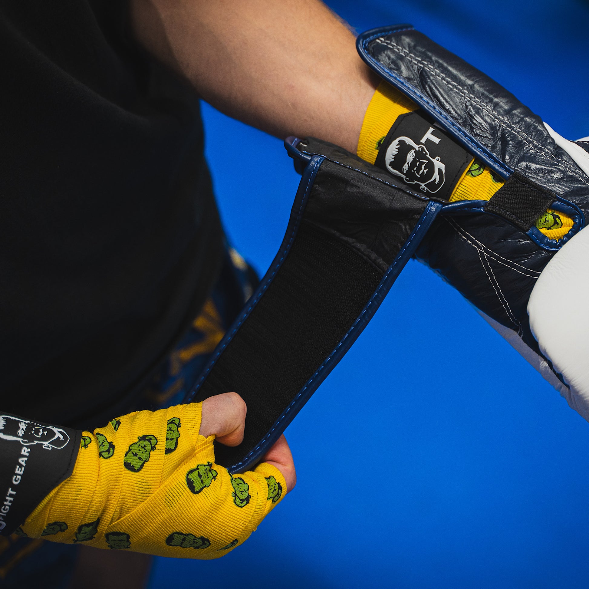 THS Fight Gear yellow with Frankenstein monster hand wraps hands wrapped putting on glove front view modelled