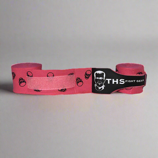 THS Fight Gear pink with printed skulls hand wraps one half rolled front view