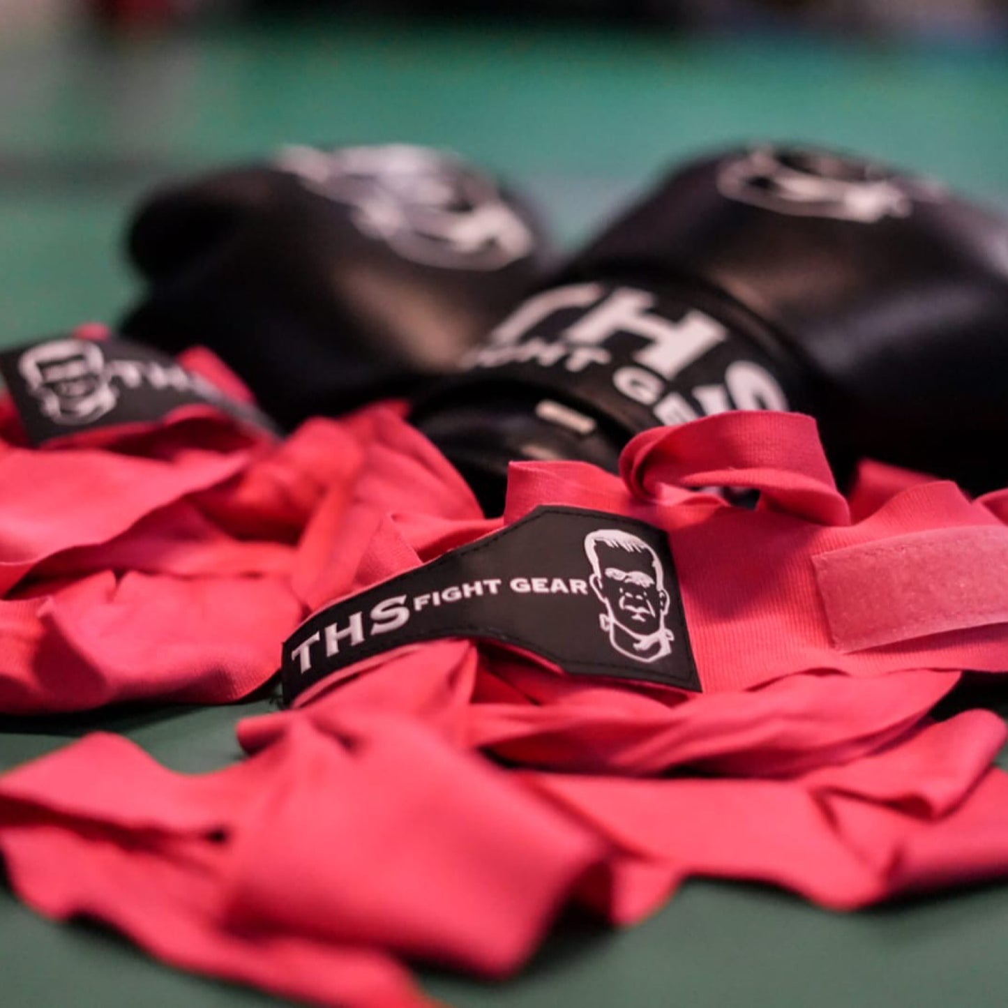 THS Fight Gear pink hand wraps bundled on the floor
