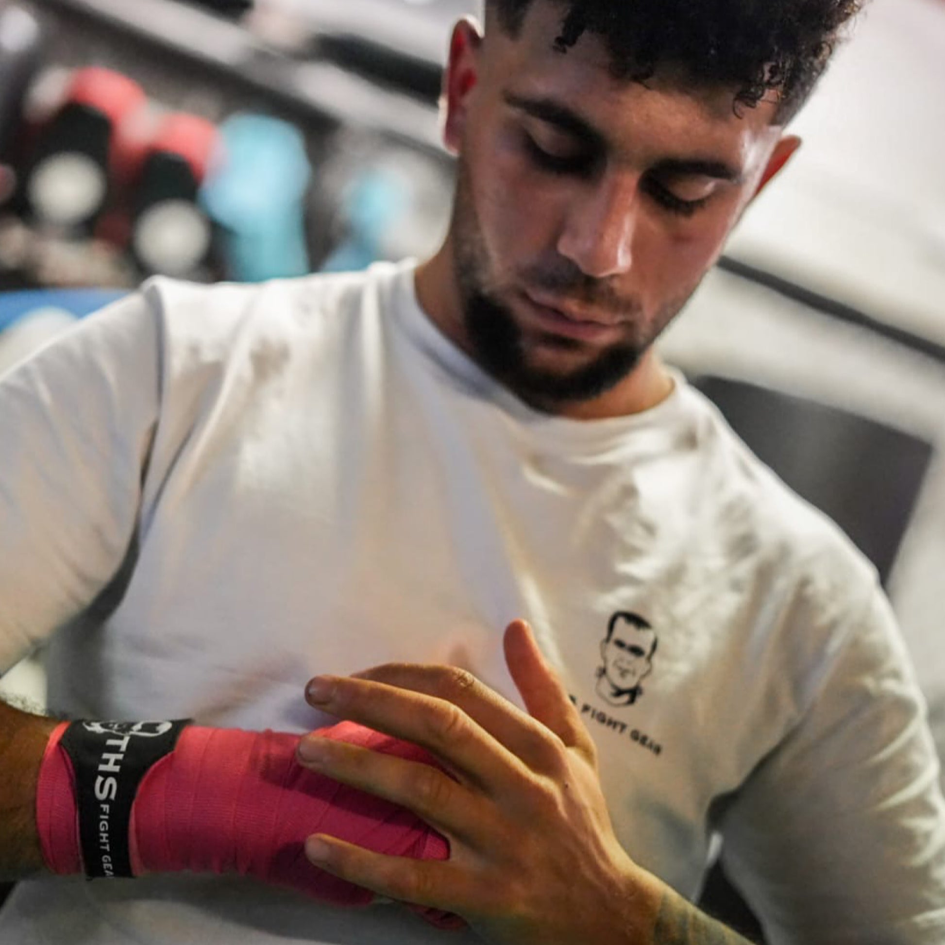 THS Fight Gear pink hand wraps in tight fist modelled front view