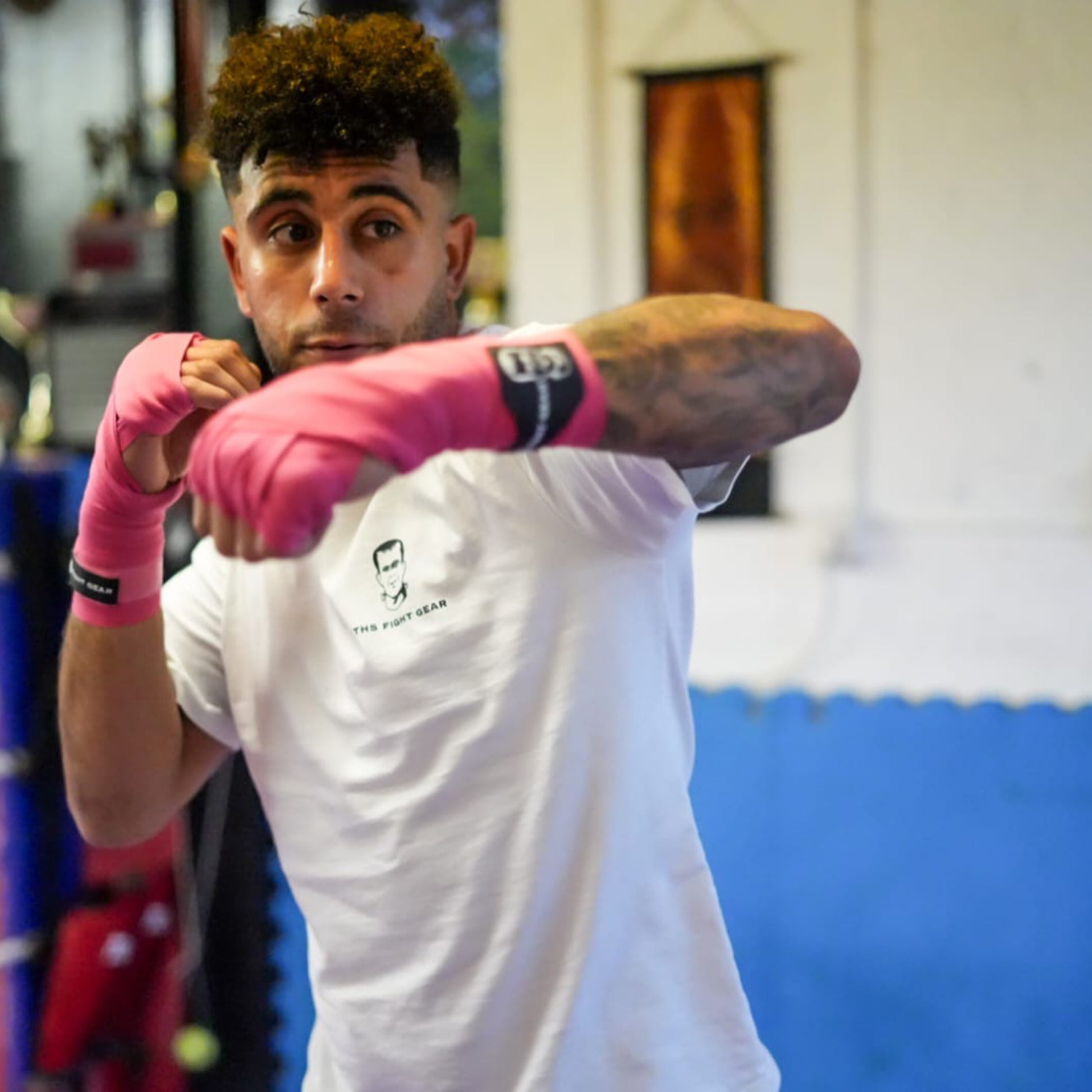 THS Fight Gear pink hand wraps left hook modelled front view