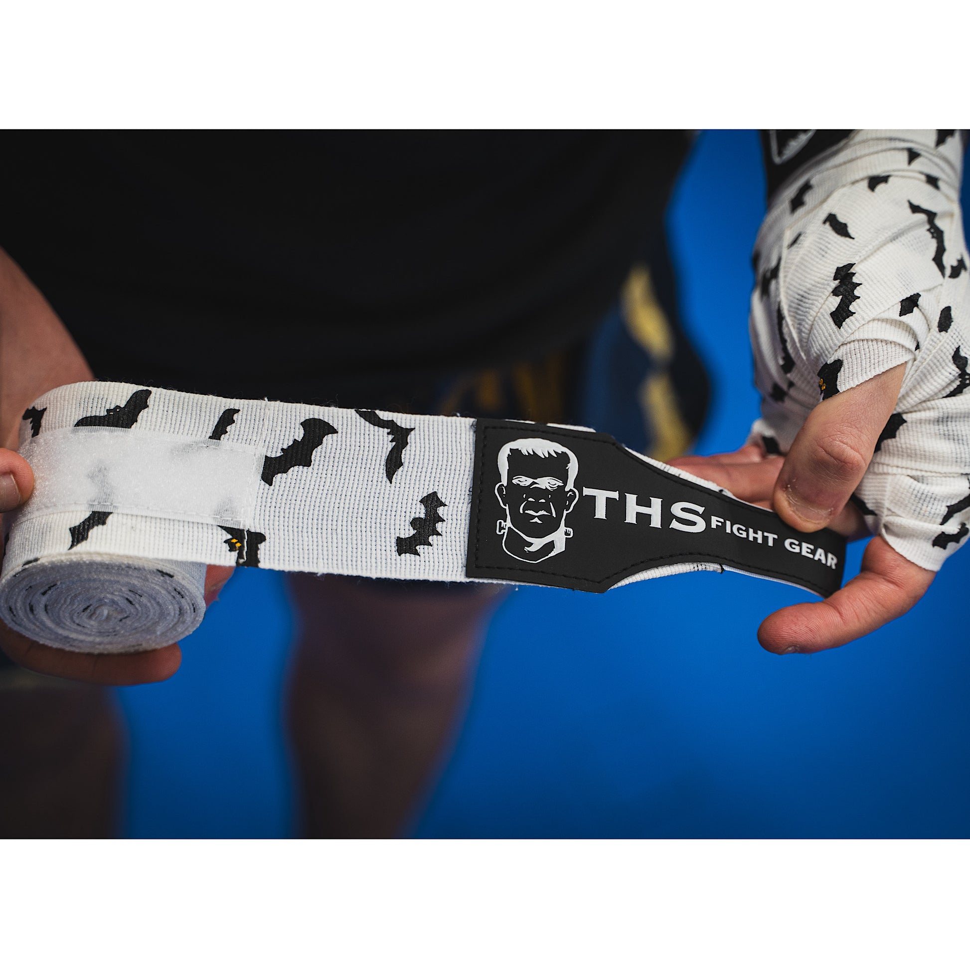THS Fight Gear white with bats hand wraps one wrap half rolled front view modelled