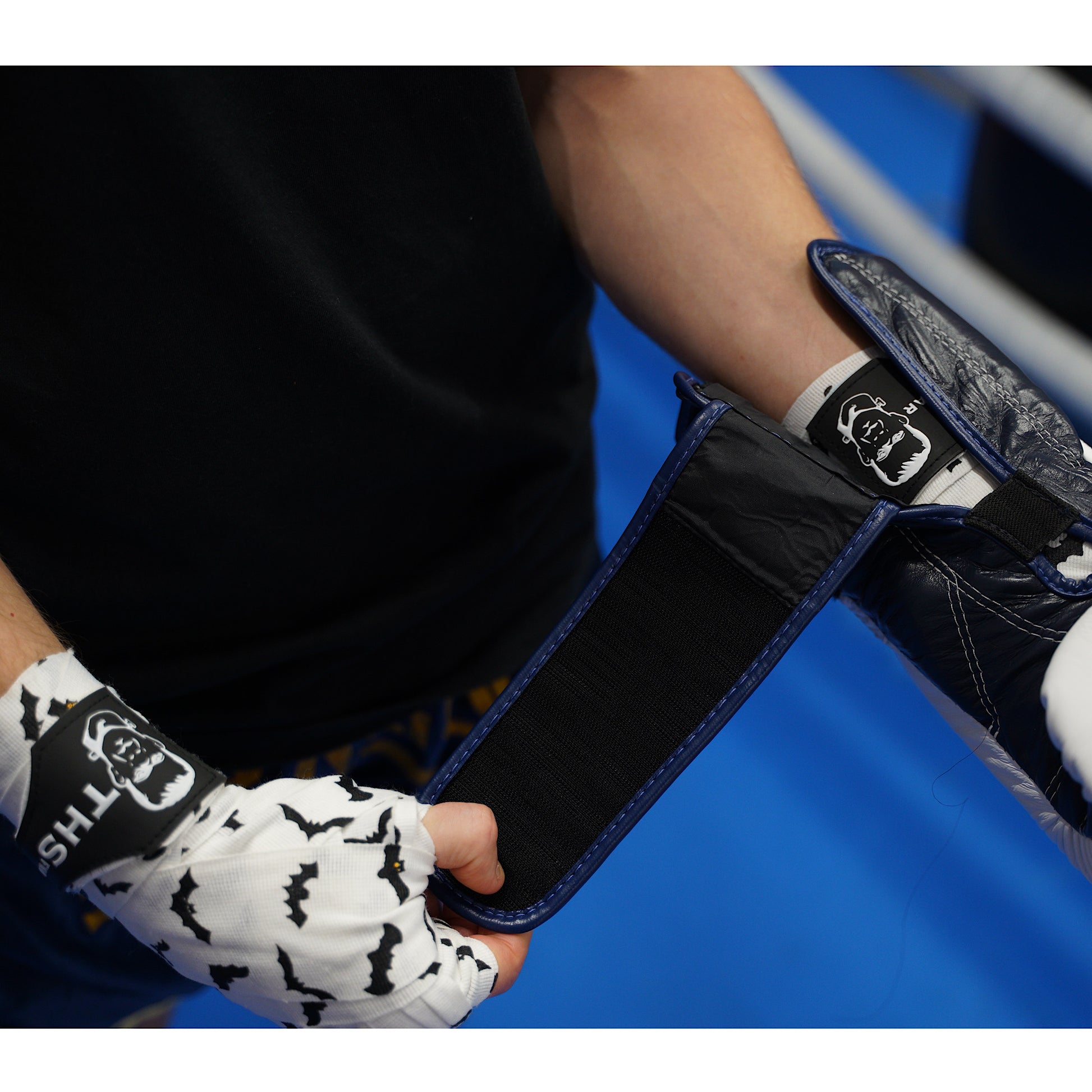 THS Fight Gear white with bats hand wraps wrapped hands putting on glove modelled