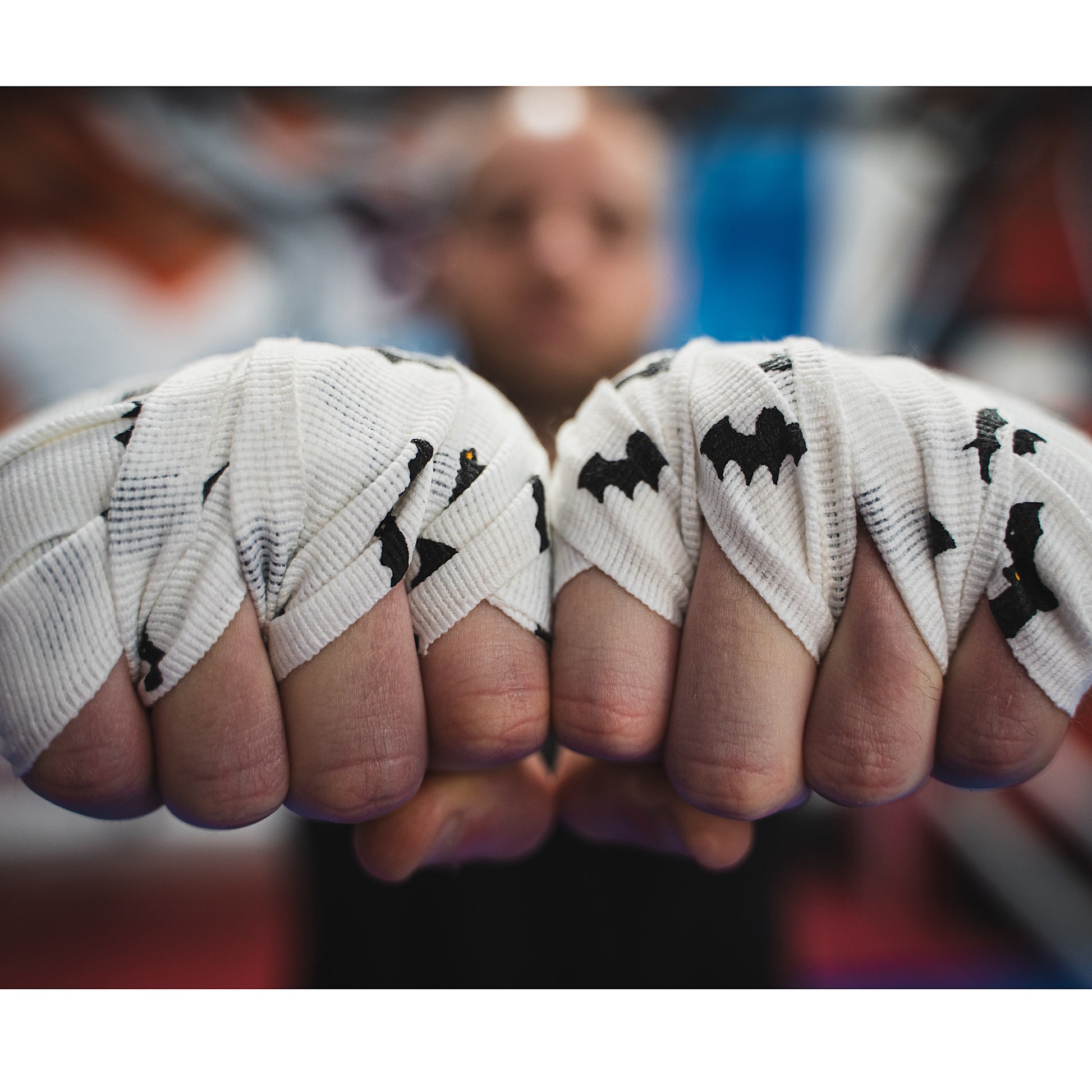 THS Fight Gear white with bats hand wraps wrapped hands tight fists front view modelled