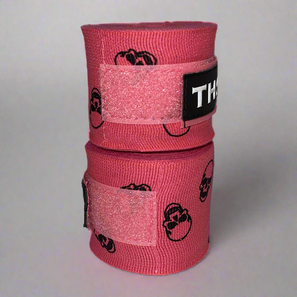THS Fight Gear pink with printed skulls hand wraps stacked rolled front view
