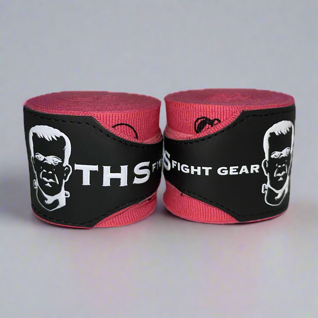 THS Fight Gear pink with printed skulls hand wraps two rolled front view