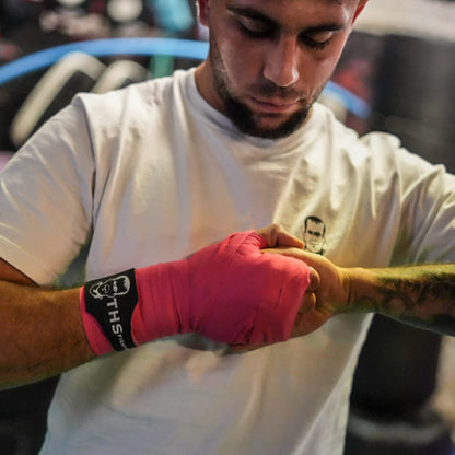 THS Fight Gear pink hand wraps finger grip modelled front view